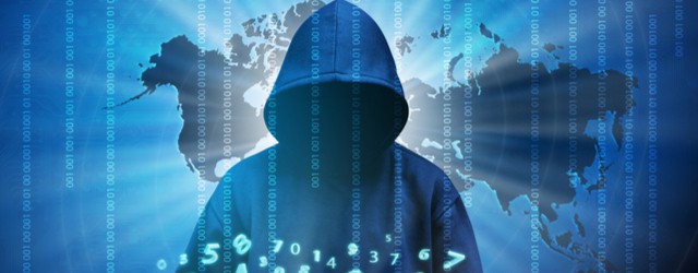 Hooded cyber criminal standing in front of electronic screen